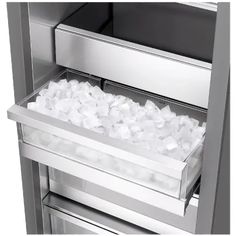 an open refrigerator with ice and water in the bottom drawer that is filled with ice cubes