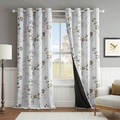 a living room with white walls and curtains