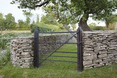 a stone wall with a gate in the middle