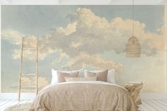 a bedroom with clouds painted on the wall and a ladder leaning up against the bed