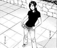 a girl is standing on the sidewalk with her hands in her pockets