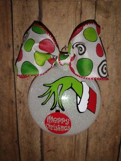 a white christmas ornament with green and red polka dots on it's head