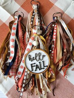 some ribbons are hanging on a table with a sign that says, we're fall