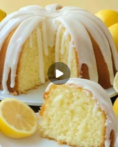 a lemon bunt cake with white icing and sliced lemons on the side