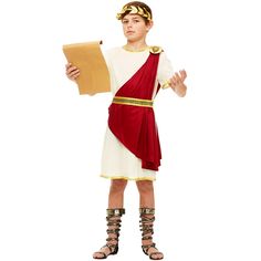 a young boy dressed in an ancient greek costume holding a piece of paper and wearing gladia sandals