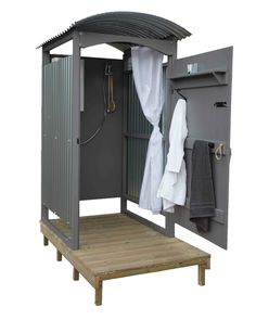 an outdoor shower is shown with the door open