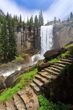 stairs lead up to a waterfall in the woods