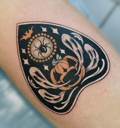 a close up of a person's arm with a clock and snake on it