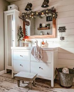 a bathroom decorated for christmas with wreaths and lights