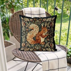 a pillow with a squirrel on it sitting on a chair