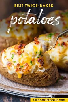 a fork is lifting up some baked potatoes with cheese and bacon on them, sitting on a plate