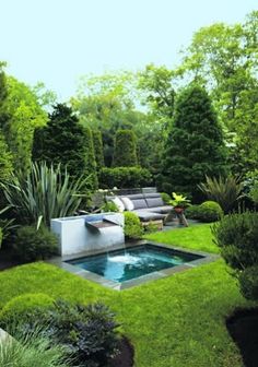 an outdoor pool surrounded by lush green grass