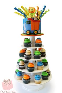 cupcakes are arranged in the shape of a train on top of a cake stand