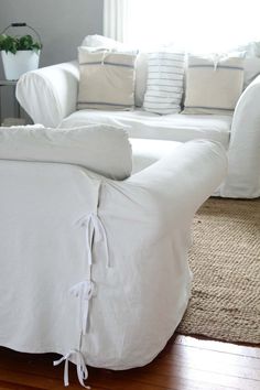 a white couch sitting on top of a hard wood floor