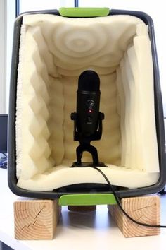 a recording booth with a microphone in it and text overlay that reads, desktop vocal recording booth on the cheap