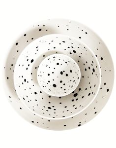 black and white polka dot bowls stacked on top of each other with one bowl in the middle