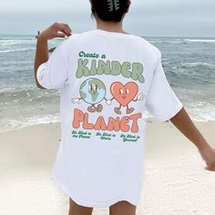 Create a Kinder Planet Y2K Tshirt. This soft Comfort Colors tee makes a great gift for anyone that likes to spread environmental awareness! Size up for a trendy oversized fit. Gildan is back with its garment-dyed t-shirt, a fully customizable tee made 100% with ring-spun cotton. The soft-washed, garment-dyed fabric brings extra coziness to your wardrobe while the relaxed fit makes it an excellent daily choice. The double-needle stitching throughout the tee makes it highly durable while the lack Oversized Cartoon Print T-shirt For Summer, Oversized Summer T-shirt With Cartoon Print, Oversized Cartoon Print Graphic Tee, Oversized Cartoon Print T-shirt For Spring, Cute Oversized T-shirt With Screen Print, Oversized White T-shirt With Funny Print, Oversized Fun T-shirt With Funny Print, Fun Oversized Graphic Print T-shirt, Oversized Fun Graphic Print T-shirt