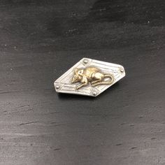 This silver brooch is handcrafted in the USA (Jersey City, New Jersey!) from SCS certified recycled sterling silver embellished with a brass rat or mouse stamping, from an antique mold.  Brooch base is entirely made from 925 sterling silver —  including the pin and hinge mechanism at the back.  This brooch may be petite in size, but the hand-carved detailing and the contrasting and highly detailed brass rat really make it pop, adding plenty of oomph to any outfit!Brooch measurements:Height: 1.7 Unique Sterling Silver Brooch In Silver, Silver Heirloom Engraved Brooches, Silver Engraved Heirloom Brooches, Unique Silver Brooch Pin, Silver Heirloom Hallmarked Brooches, Heirloom Hallmarked Silver Brooches, Heirloom Silver Hallmarked Brooches, Unique Collectible Silver Pins, Collectible Silver Brooch Pins