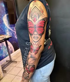 a woman with a butterfly tattoo on her arm