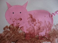 a paper cut out of a pig standing on top of a pile of brown dirt