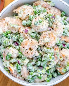 a bowl filled with shrimp and pea salad