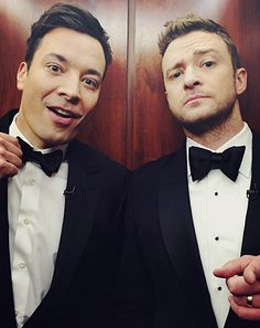 two men in tuxedos posing for a photo