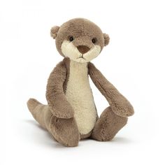 a stuffed otter is sitting on the ground