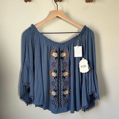 Brand New With Tags Altar’d State Top Boho Vibes Bell Sleeve Off The Shoulder Style Embroidered Rayon Spandex Blend Measurements Pictured Smoke Free Pet Free Home Box J Bohemian Flowy Embroidered Top With Floral Design, Flowy Bohemian Top With Floral Embroidery, Casual Blue Peasant Top With Floral Embroidery, Casual Blue Embroidered Peasant Top, Blue Embroidered Folk Peasant Top, Blue Bohemian Embroidered Top, Flowy Bohemian Embroidered Top, Blue Flowy Bohemian Peasant Top, Blue Peasant Blouse With Floral Embroidery