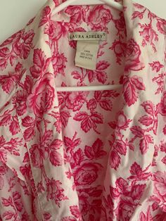 Gorgeous hot pink floral Laura Ashley rare Parisian line wrap robe. Ruffles at bodice and at sleeve ends. Cotton.  Rare robe.  Matching self tie.  Tagged size large  Bust flat is open at front and measured at back is 22 inches flat Length is 50-51 inches Sleeve is dropped at shoulder and measures 30 inches.  Please verify measurements.  Sold as is. No returns.  No issues to note.  Final sale Spring Floral Print Fitted Robe, Vintage Pink Robe For Spring, Fitted Floral Print Spring Robe, Fitted Floral Print Robe For Spring, Vintage Pink Robe For Loungewear, Fitted Long Sleeve Floral Print Robe, Long-sleeved Pink Vintage Robe, Pink Spring Robe For Loungewear, Pink Vintage Floral Print Sleepwear