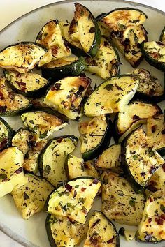 a white plate topped with sliced up zucchini