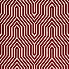 a red and white rug with an abstract design