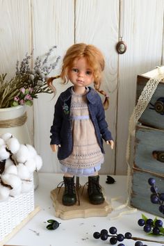 a doll is standing next to some cotton