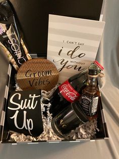 the groom's gift box is filled with grooms and groomsmid items