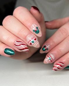 Featuring playful Mickey Mouse heads with green and red glitter accents, this design brings a touch of Disney magic to your Christmas nails. The almond shape and festive color palette make this design perfect for both holiday red and green themes. The candy cane stripes and cute little holly details add an extra layer of Christmas cheer. Christmas Nail Designs Easy, Disney Christmas Nails, Mickey Nails, Cute Christmas Nails, Christmas Nails Easy, Christmas Gel Nails, Disney Nails, Nail Swag, Festival Nails