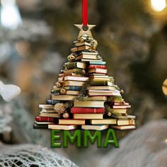 a christmas tree made out of books with the word emma written on it's bottom