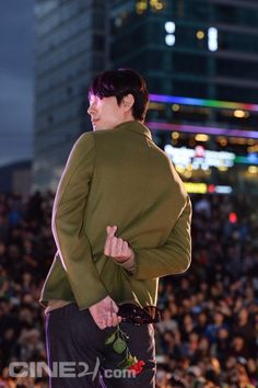 a man standing on top of a stage in front of a large group of people