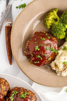 meatloaf with gravy, mashed potatoes and broccoli on a plate