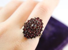 -Antique Sterling Silver Dark Red Natural Garnet Ring -Ring size: 7 US -Ring head size: 22 mm x 17 mm -Middle garnet size: 4.5 mm x 3 mm -Total weight: 5.8 g -Tested silver Formal Red Garnet Cluster Ring, Antique Red Cluster Ring Gift, Oval Red Garnet Cluster Ring, Red Oval Garnet Cluster Ring, Fine Jewelry Garnet Cluster Ring In Red, Fine Jewelry Red Garnet Cluster Ring, Garnet Ring, New City, Garnet Rings