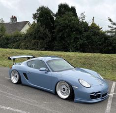 a blue sports car parked in a parking lot