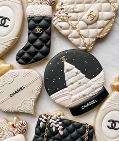 cookies decorated like chanel bags and purses are laid out on a white surface