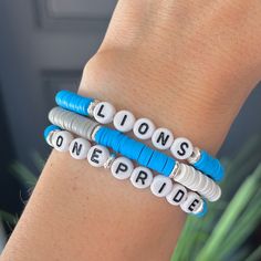 Detroit Lions Bracelet! One Pride Bracelet! Go Lions! Cheer on your team with these great bracelets! Each bracelet is sold individually. Or buy a Stack of 3! Coordinating earrings also available. Use drop down box to select.  Customization available: If you would like the bracelet to say something else (Grit, Goff,  Hutch, etc) please message me to order.  SIZE  * Stretch Bracelet, size is approximately 6 3/4"-7" (fits small to medium wrists) If you need a different size please let us know in no Personalized Blue Bracelets For Sports Events, Blue Team Spirit Beaded Bracelets As Gift, Blue Beaded Bracelets For Team Spirit Gift, Adjustable White Bracelets For Team Events, Adjustable Personalized Team Spirit Jewelry, White Team Spirit Jewelry As A Gift, White Team Spirit Jewelry For Gifts, White Team Spirit Jewelry Gift, Lion Bracelet