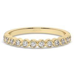 a yellow gold wedding band with five round diamonds