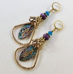 Hand-Painted Earrings. The centerpiece of these earrings are the beautiful hand-painted on copper with resin charms made by Washington State artist Kristi. I accented them with rounded triangle connectors, vintage brass bead caps, purple faceted Czech glass beads and turquoise Swarovski crystal bicone beads. These earrings are 3 inches long including the pure brass round lever back closures. One Of A Kind I can send it gift wrapped (free of charge), if requested. Handmade Bronze Czech Glass Earrings, Vintage Multicolor Brass Earrings, Bohemian Enamel Earrings Nickel-free, Nickel-free Bohemian Enamel Earrings, Bohemian Enamel Earrings Nickel Free, Artsy Brass Drop Earrings, Handmade Bronze Brass Teardrop Earrings, Artsy Brass Dangle Jewelry, Nickel-free Bronze Artsy Earrings