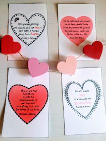 four valentine's day cards with hearts hanging from clothes pins on a string,