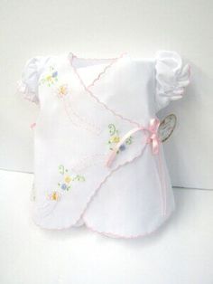 Adorable white batiste diaper set with pink scalloped trim and darling embroidery of multi-colored flowers, stems, and fluttering butterflies, with pink satin tie side closure, puff sleeves with pink scalloped cuff. Baby Romper Sewing Pattern, Baby Diy Sewing, Baby Heirloom, Romper Sewing Pattern, Fluttering Butterflies, Quilt Sewing Patterns, Bear Quilts, Baby Quilt Patterns, Baby Dress Patterns