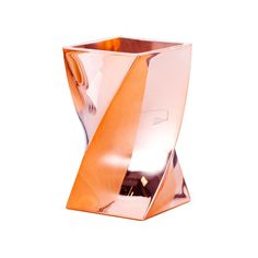 an orange vase sitting on top of a white table