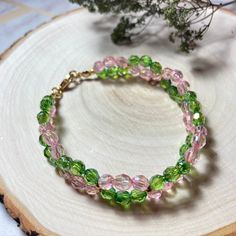 Dressy pink and green twisted faceted glass bead bracelet, round gold accents and gold lobster clasp Pink Czech Glass Bracelets With Faceted Beads, Pink Faceted Beaded Bracelets, Twist Bracelet, Glass Bead Bracelet, Twisted Bracelet, Memorial Bracelet, Glass Beaded Bracelets, Faceted Glass, Kids Jewelry