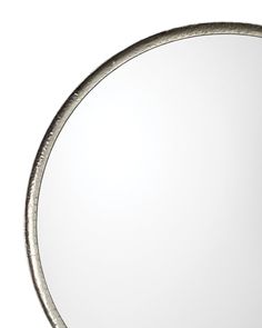 a round metal mirror on a white background