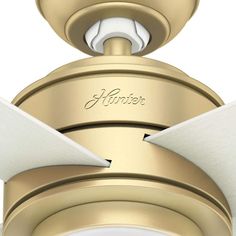 a close up view of the top of a ceiling fan that is gold and white