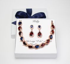 "I've created this set using top navy AAA cubic zirconia posts matched with bottom tear drop burgundy pendants, and matching necklace and bracelet set. They are in Rose gold, Gold and White gold (silver colored) plated settings, nickel and lead safe, and are tarnish resistant. I've set the bracelet with double burgundy and one navy stones for custom pattern design. Other stone colors and patterns are also available at your request (please see last picture for color reference). Bracelet measures Crystal Jewelry With Matching Earrings For Gifts, Red Cubic Zirconia Jewelry Gift, Personalized Crystal Jewelry For Party, Party Jewelry With Birthstone In Cubic Zirconia, Cubic Zirconia Birthstone Jewelry For Party, Crystal Jewelry Sets For Gifts, Elegant Red Jewelry For Bridesmaid Gift, Personalized Crystal Jewelry For Wedding, Elegant Red Jewelry For Bridesmaid